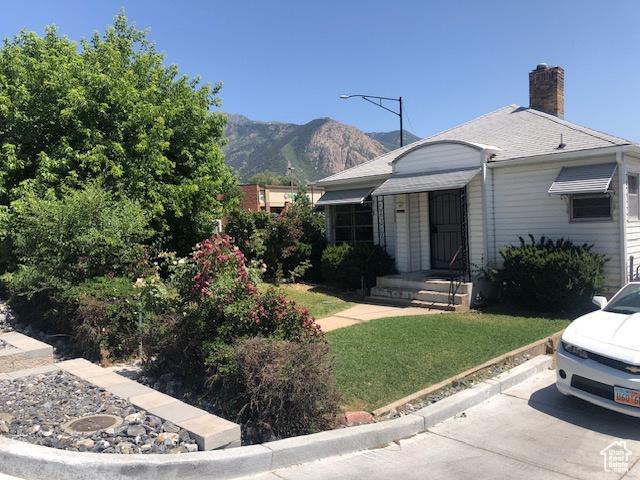 1191 E 20th, Ogden, UT 84401 - view of front of home with a mountain view, a chimney, and a front yard