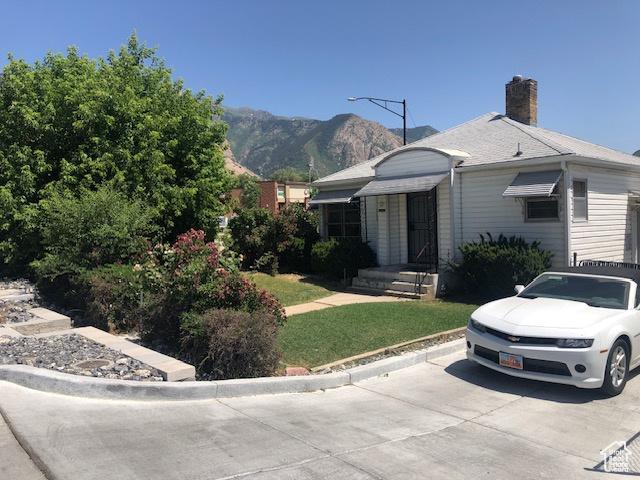 1191 E 20th, Ogden, UT 84401 - view of front of house featuring a mountain view, a chimney, and a front lawn