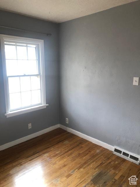 1191 E 20th, Ogden, UT 84401 - unfurnished room featuring wood finished floors and baseboards