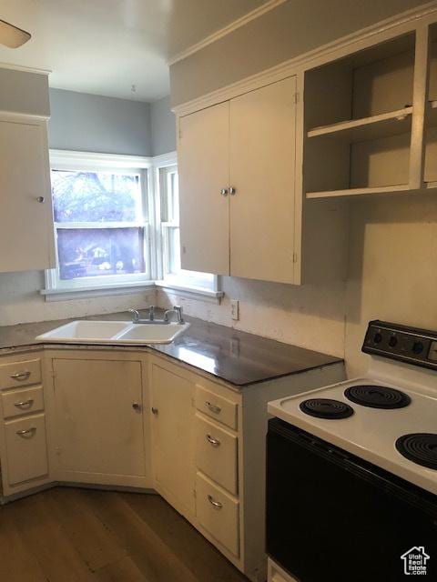 1191 E 20th, Ogden, UT 84401 - kitchen with white electric range oven, white cabinets, and dark wood-type flooring