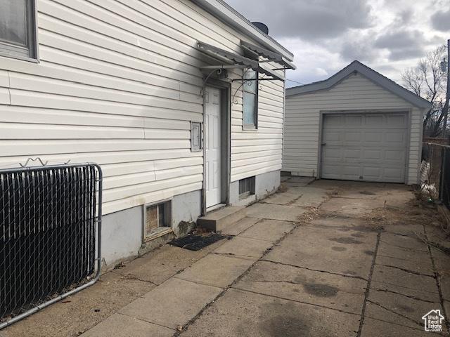1191 E 20th, Ogden, UT 84401 - view of home's exterior with an outdoor structure and concrete driveway