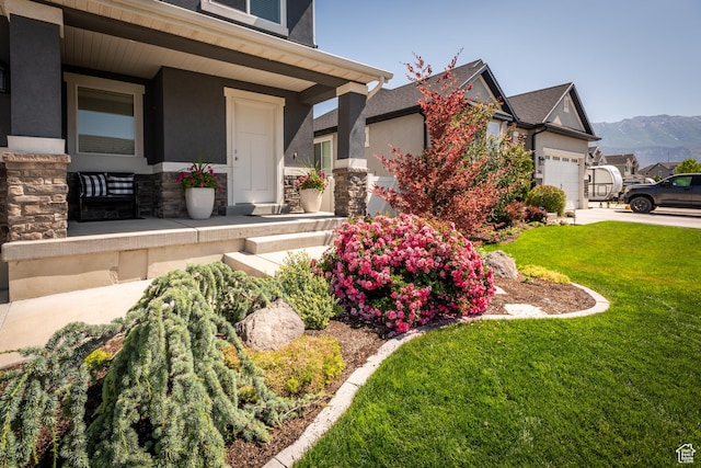 244 W 380 S Unit 10B, American Fork, UT 84003 - view of side of home with a porch, stone siding, stucco siding, and a lawn