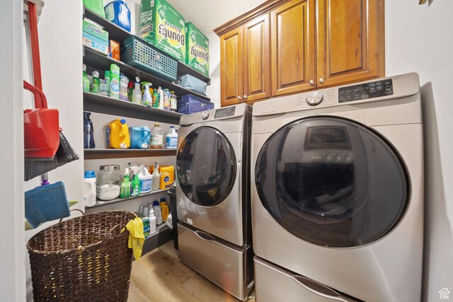 3601 S 5650 W, West Valley City, UT 84128 - laundry room featuring washing machine and dryer, wood finished floors, and cabinet space
