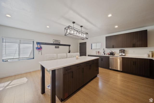 3601 S 5650 W, West Valley City, UT 84128 - kitchen featuring stainless steel dishwasher, dark brown cabinets, light countertops, light wood-type flooring, and recessed lighting