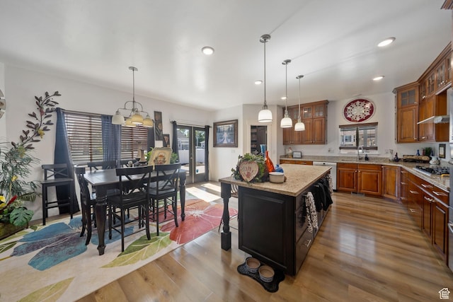 3601 S 5650 W, West Valley City, UT 84128 - kitchen featuring brown cabinets, glass insert cabinets, hanging light fixtures, wood finished floors, and recessed lighting