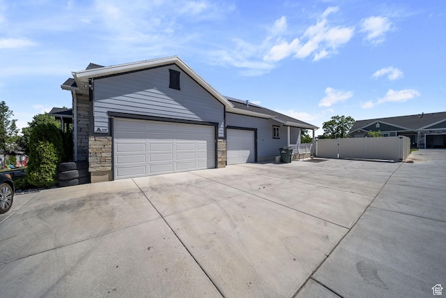 3601 S 5650 W, West Valley City, UT 84128 - ranch-style house featuring driveway, an attached garage, and stone siding