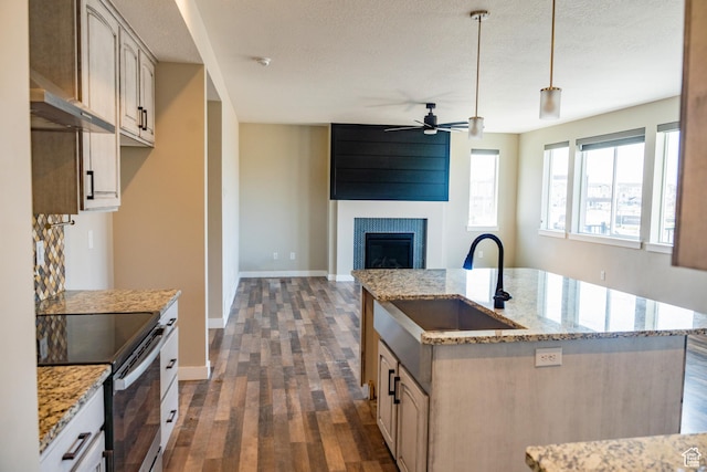 1272 E 1470 N, Payson, UT 84651 - kitchen with stainless steel range with electric stovetop, a ceiling fan, dark wood finished floors, a fireplace, and pendant lighting
