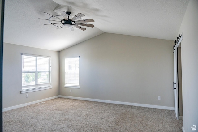 1272 E 1470 N, Payson, UT 84651 - carpeted spare room featuring lofted ceiling, a textured ceiling, ceiling fan, and a barn door