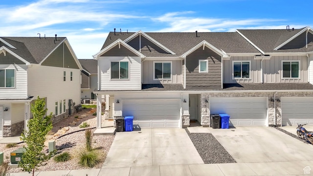 631 W 550 N, Smithfield, UT 84335 - townhome / multi-family property featuring board and batten siding, stone siding, a garage, concrete driveway, and a shingled roof