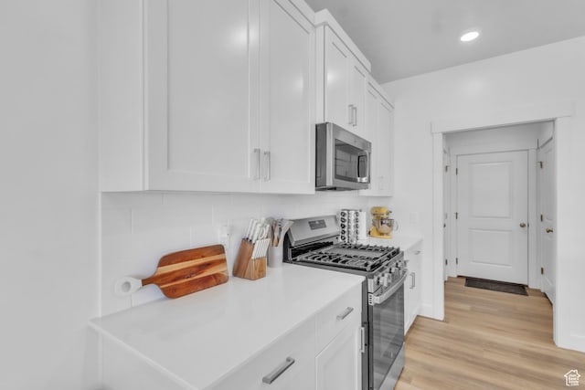 631 W 550 N, Smithfield, UT 84335 - kitchen featuring stainless steel appliances, white cabinetry, backsplash, light countertops, and recessed lighting