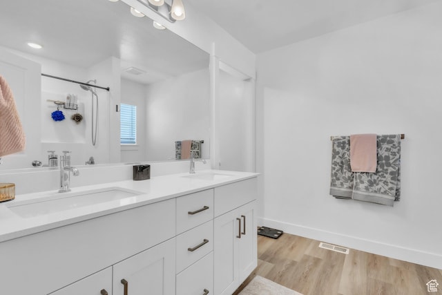 631 W 550 N, Smithfield, UT 84335 - full bathroom featuring double vanity, wood finished floors, and a shower