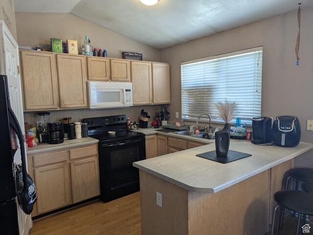 1831 W Dale Ridge Ave N, Salt Lake City, UT 84116 - kitchen featuring black appliances, light brown cabinets, a peninsula, light wood-style floors, and vaulted ceiling