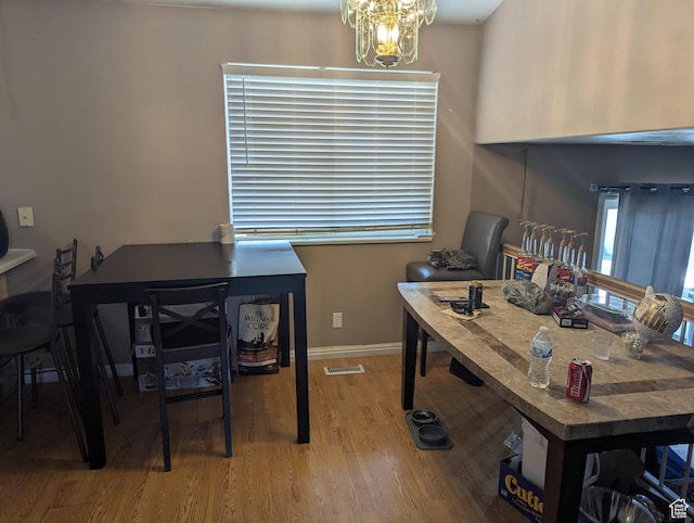 1831 W Dale Ridge Ave N, Salt Lake City, UT 84116 - dining space featuring wood finished floors and a chandelier