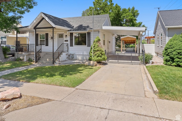341 E 700 N, Spanish Fork, UT 84660 - view of front facade featuring driveway, a front yard, an attached carport, roof with shingles, and a gate