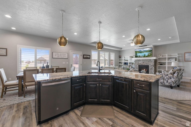 5671 S 650 E, Washington Terrace, UT 84405 - kitchen with stainless steel dishwasher, a textured ceiling, wood finished floors, a fireplace, and plenty of natural light