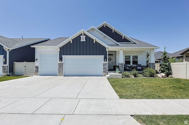 5671 S 650 E, Washington Terrace, UT 84405 - craftsman inspired home featuring board and batten siding, a garage, a porch, driveway, and stone siding