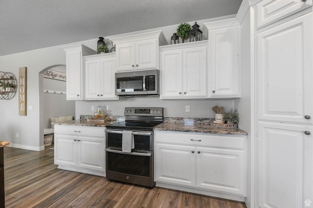 5671 S 650 E, Washington Terrace, UT 84405 - kitchen featuring stainless steel appliances, dark wood-style floors, white cabinetry, dark stone countertops, and a textured ceiling