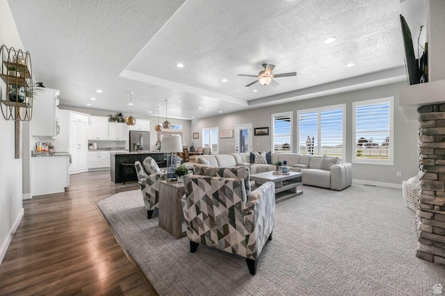 5671 S 650 E, Washington Terrace, UT 84405 - living area featuring a textured ceiling, ceiling fan, dark wood-style floors, a raised ceiling, and recessed lighting