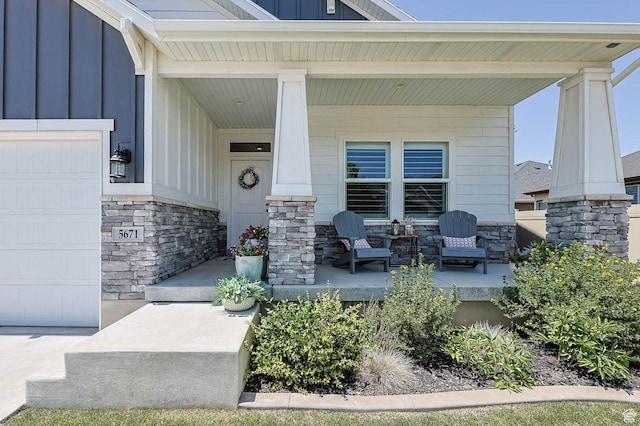 5671 S 650 E, Washington Terrace, UT 84405 - doorway to property with a porch, stone siding, board and batten siding, and an attached garage