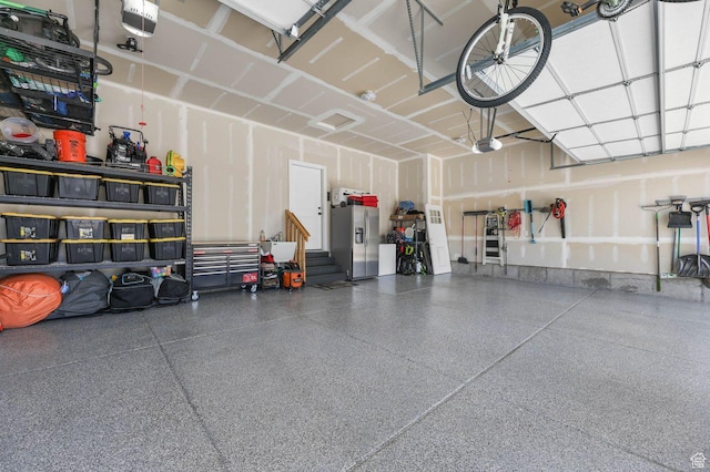5671 S 650 E, Washington Terrace, UT 84405 - garage with stainless steel fridge and a garage door opener
