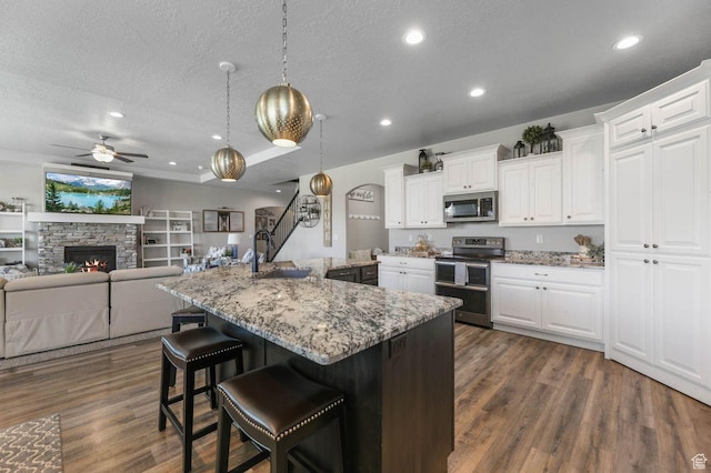 5671 S 650 E, Washington Terrace, UT 84405 - kitchen with stainless steel appliances, a textured ceiling, a ceiling fan, dark wood-style flooring, and open floor plan