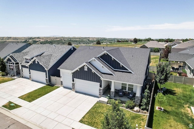 5671 S 650 E, Washington Terrace, UT 84405 - view of front of home with board and batten siding, an attached garage, stone siding, and concrete driveway