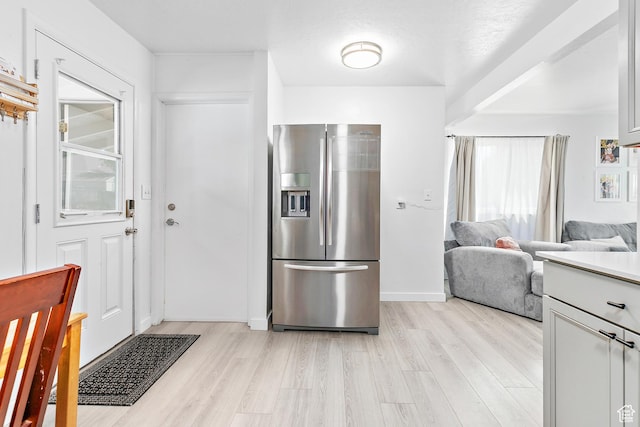 8829 S 40 E, Sandy, UT 84070 - kitchen with stainless steel fridge with ice dispenser, light wood-style floors, open floor plan, and light countertops