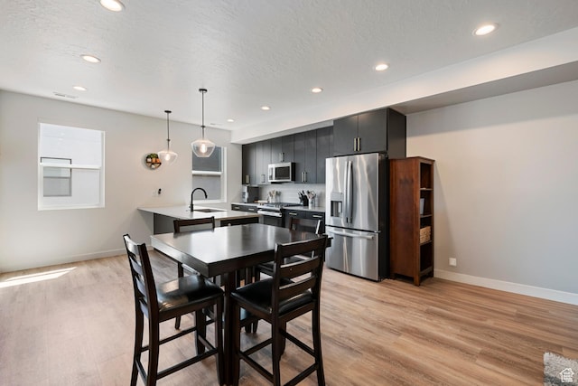 507 W 620 N Unit 127, Centerville, UT 84014 - dining area with light wood finished floors, recessed lighting, and a textured ceiling