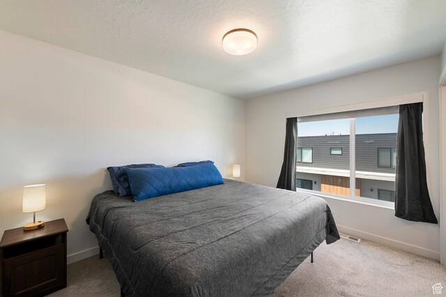 507 W 620 N Unit 127, Centerville, UT 84014 - carpeted bedroom featuring baseboards and a textured ceiling