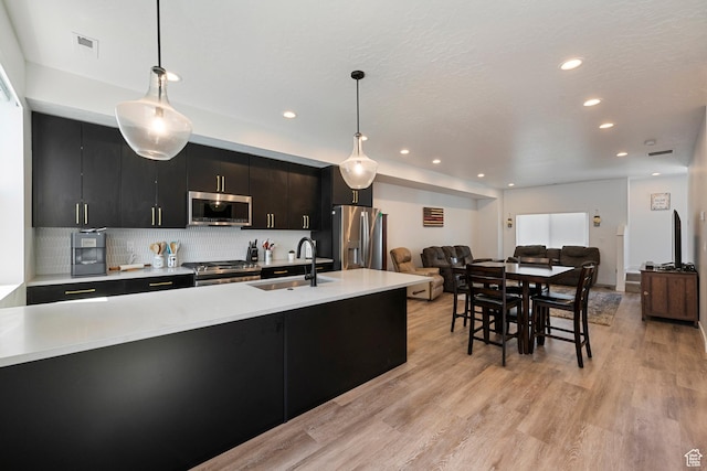 507 W 620 N Unit 127, Centerville, UT 84014 - kitchen with appliances with stainless steel finishes, light countertops, dark cabinetry, recessed lighting, and tasteful backsplash