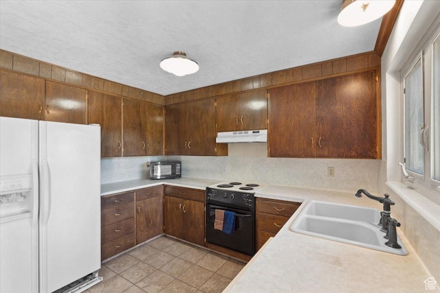 666 E Shelly Ave N, American Fork, UT 84003 - kitchen featuring black appliances, under cabinet range hood, light countertops, and light tile patterned floors