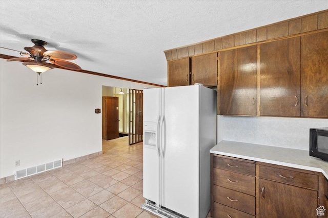 666 E Shelly Ave N, American Fork, UT 84003 - kitchen with white refrigerator with ice dispenser, light countertops, ceiling fan, black microwave, and light tile patterned flooring