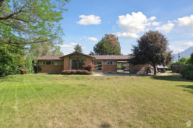 666 E Shelly Ave N, American Fork, UT 84003 - back of property featuring brick siding, an attached carport, and a lawn