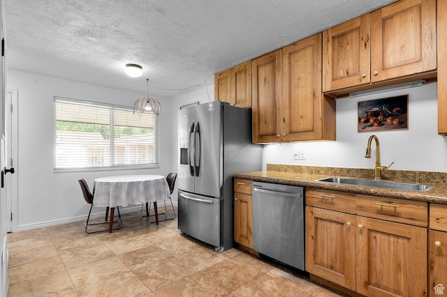314 W Center St Unit 123, Bountiful, UT 84010 - kitchen featuring stainless steel appliances, brown cabinets, dark countertops, a textured ceiling, and decorative light fixtures