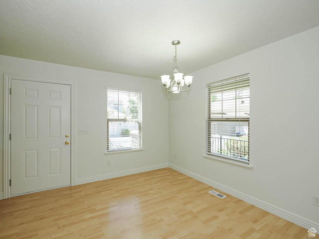 478 W 470 S, Provo, UT 84601 - unfurnished room with a chandelier, healthy amount of natural light, and light wood-style floors