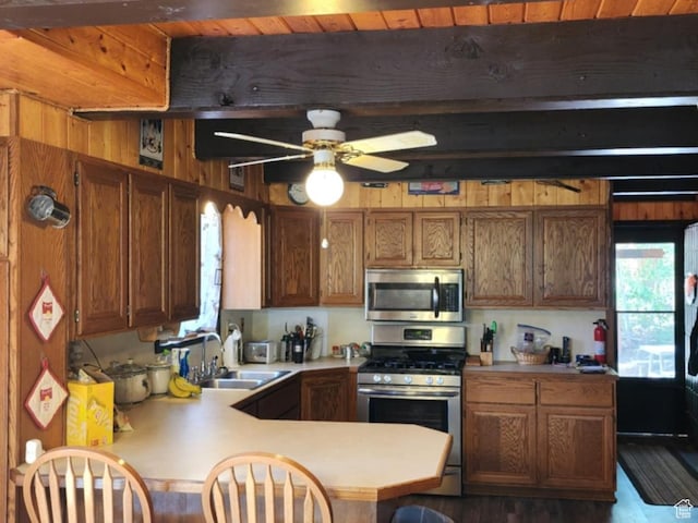11829 Falcon Pt Unit H21, Huntsville, UT 84317 - kitchen featuring stainless steel appliances, beam ceiling, ceiling fan, light countertops, and brown cabinetry