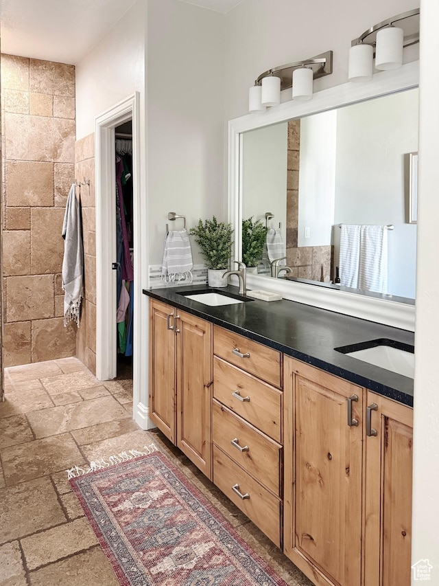 1790 S 940 W, Richfield, UT 84701 - bathroom featuring double vanity, stone tile floors, and a walk in closet