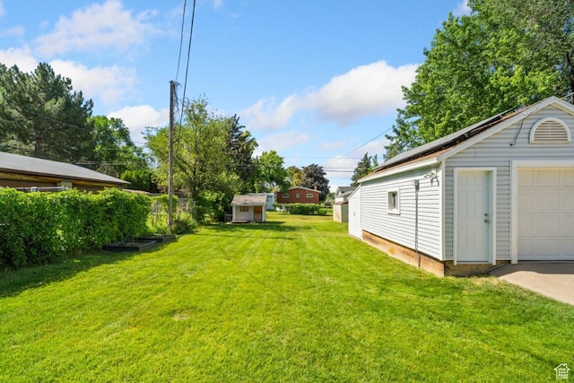 1243 Oak St, Ogden, UT 84401 - view of green lawn with an outbuilding and a garage