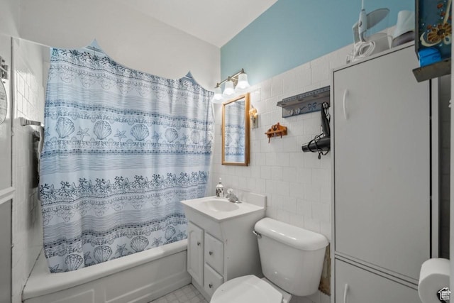 1243 Oak St, Ogden, UT 84401 - bathroom with tile walls, shower / bath combination with curtain, and vanity