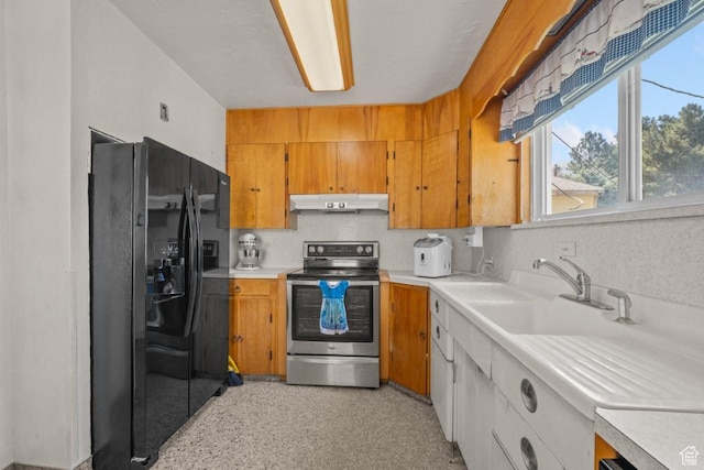 1243 Oak St, Ogden, UT 84401 - kitchen with black refrigerator with ice dispenser, stainless steel range with electric stovetop, under cabinet range hood, light countertops, and brown cabinetry