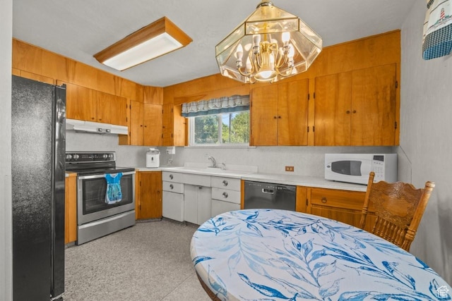 1243 Oak St, Ogden, UT 84401 - kitchen featuring black appliances, under cabinet range hood, a chandelier, light countertops, and brown cabinets