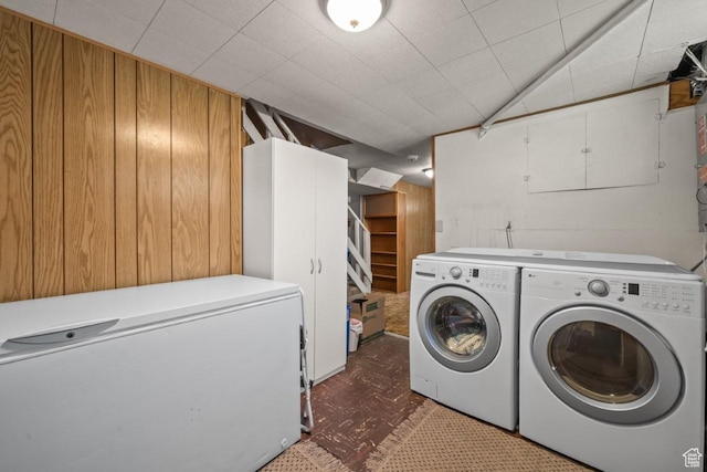 1243 Oak St, Ogden, UT 84401 - washroom featuring independent washer and dryer, wooden walls, and dark floors