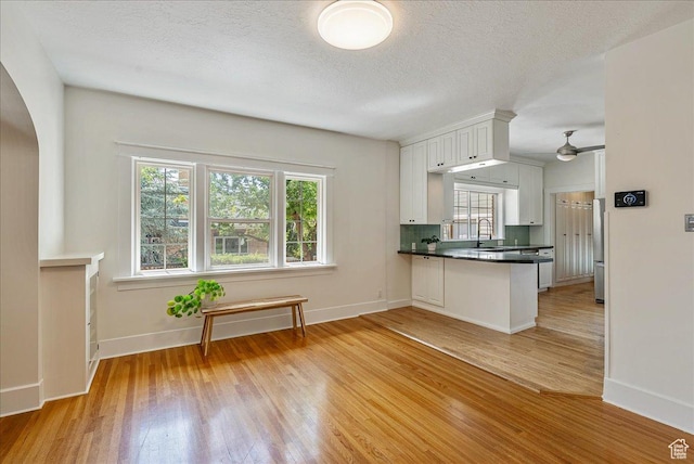 1351 E Browning Ave S, Salt Lake City, UT 84105 - kitchen featuring high end fridge, healthy amount of natural light, light wood-style floors, arched walkways, and a textured ceiling