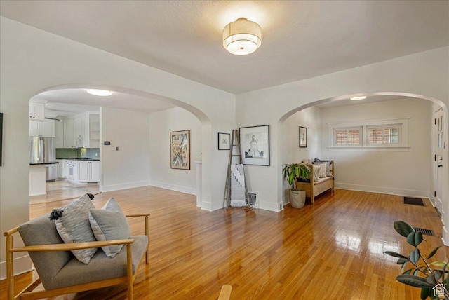 1351 E Browning Ave S, Salt Lake City, UT 84105 - living area with light wood-style floors and arched walkways