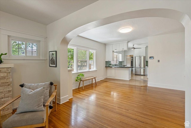 1351 E Browning Ave S, Salt Lake City, UT 84105 - sitting room featuring arched walkways, healthy amount of natural light, light wood-type flooring, and ceiling fan