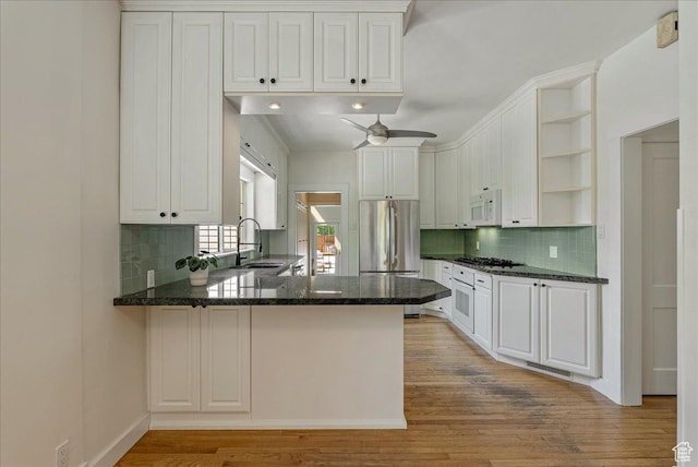 1351 E Browning Ave S, Salt Lake City, UT 84105 - kitchen with white microwave, open shelves, a peninsula, ceiling fan, and light wood finished floors