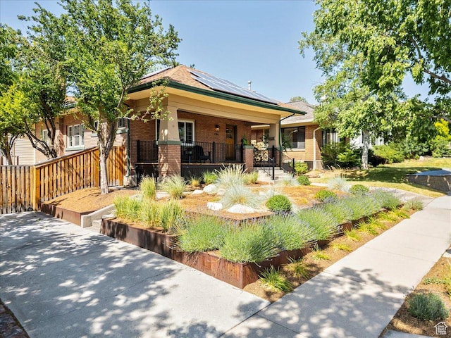 1351 E Browning Ave S, Salt Lake City, UT 84105 - view of front of house featuring brick siding, solar panels, and a porch