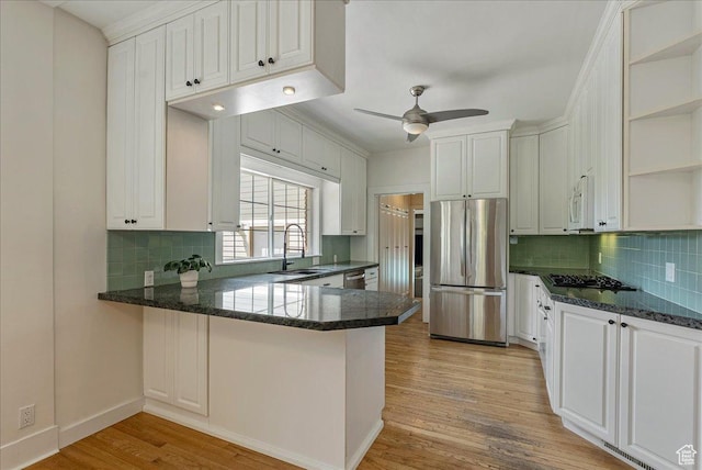 1351 E Browning Ave S, Salt Lake City, UT 84105 - kitchen with stainless steel appliances, open shelves, light wood-style flooring, a ceiling fan, and a peninsula