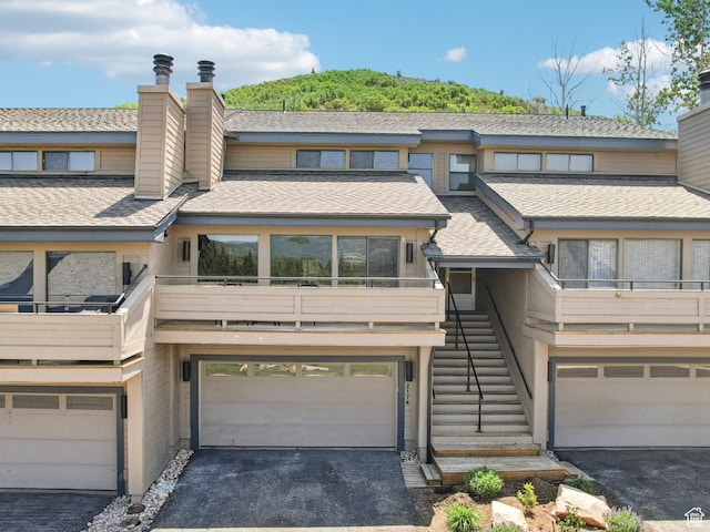2174 Fenchurch Dr, Park City, UT 84060 - view of property with a chimney, stairs, asphalt driveway, and a shingled roof