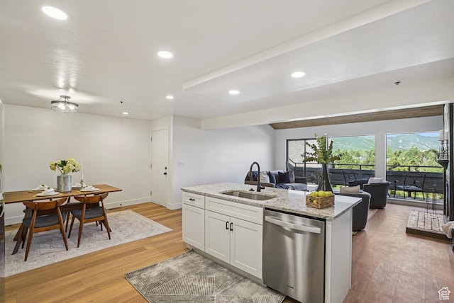 2174 Fenchurch Dr, Park City, UT 84060 - kitchen featuring stainless steel dishwasher, open floor plan, light wood-style flooring, a kitchen island with sink, and white cabinets